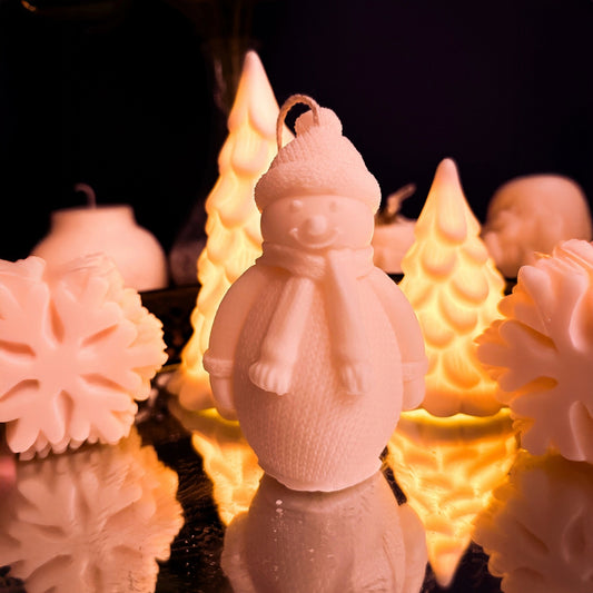 Handmade large snowman candle made from natural soy wax, wearing winter clothes with hat and scarf, cozy Christmas decorative candle for festive home decor.