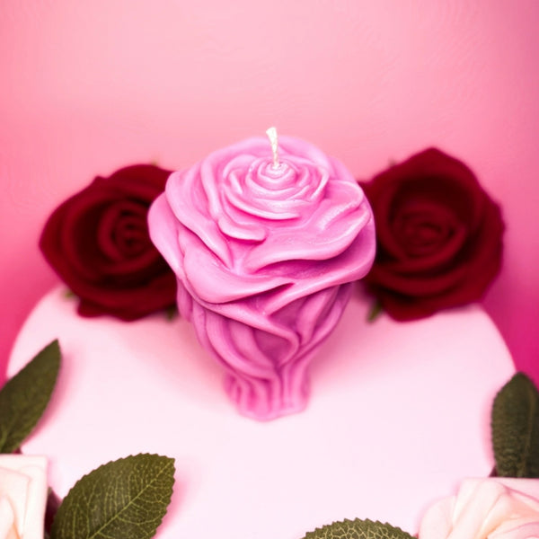 Pink handmade rose candle in soy wax styled for Valentine’s Day.
