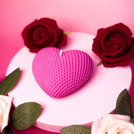 Heart-shaped soy candle in soft pink displayed with roses – Valentine’s decorative candle.