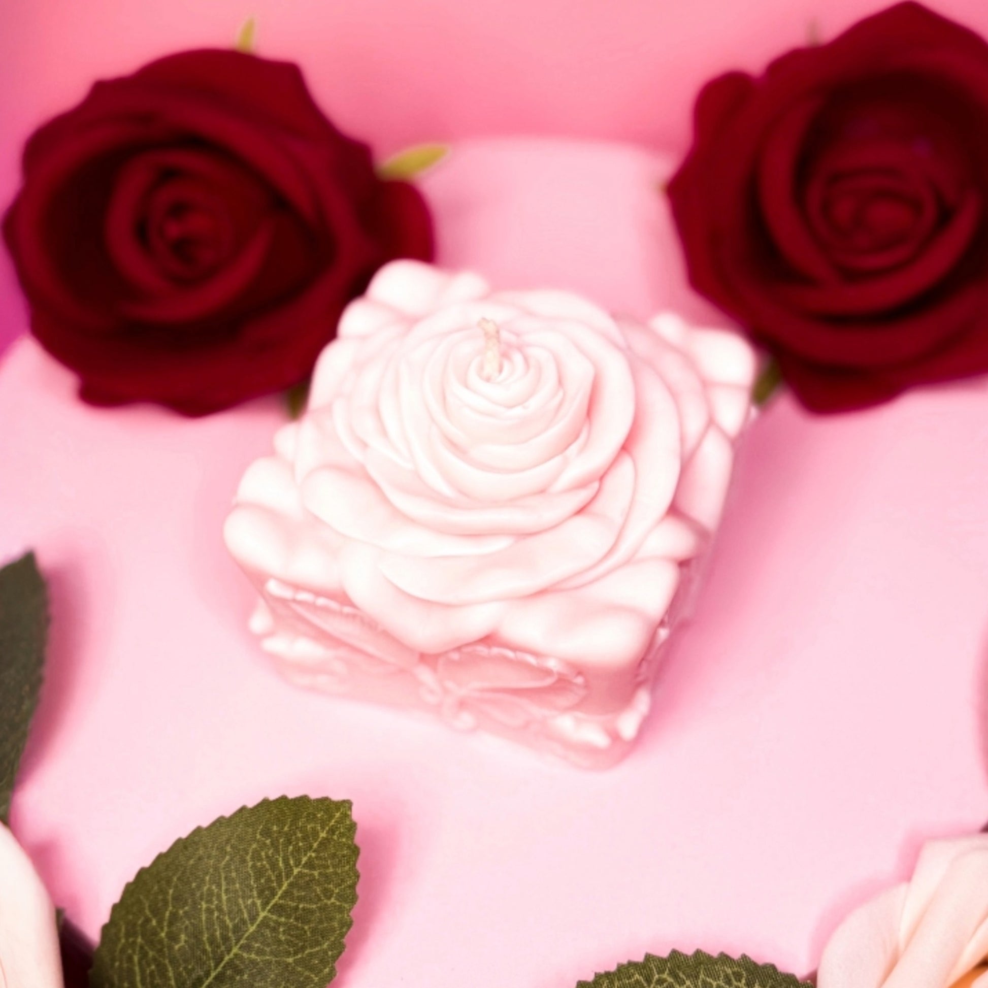 Decorative rose candle made of soy wax, romantic Valentine’s candle in soft tones.