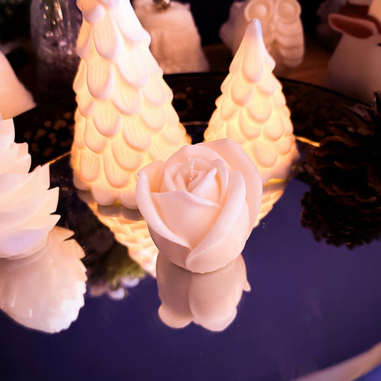 Top view of a handmade small rose-shaped soy wax candle, detailed petal formation and sculptural floral design, decorative candle for stylish home decor.