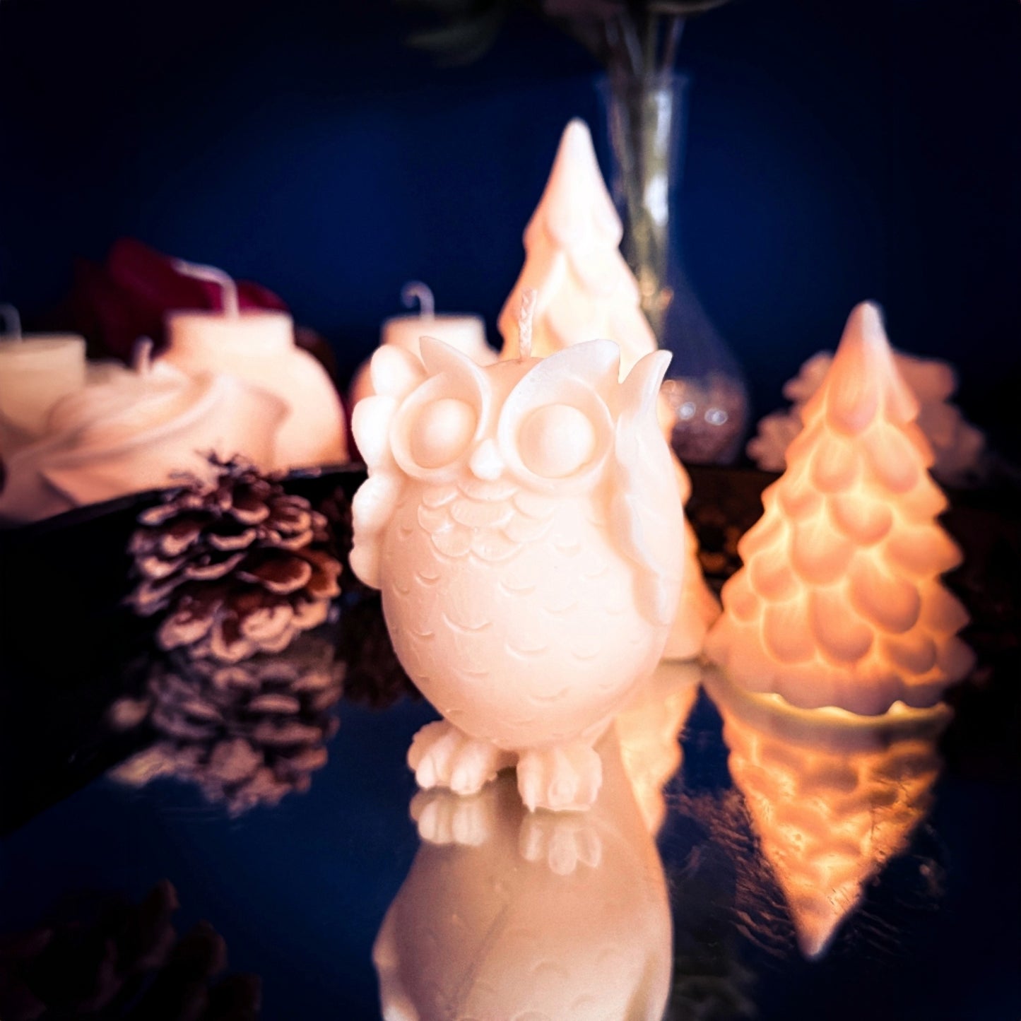 Decorative playful owl candle with soft details, photographed in warm winter setting.